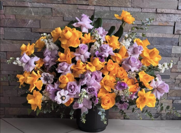 Exotic arrangement of yellow and purple roses